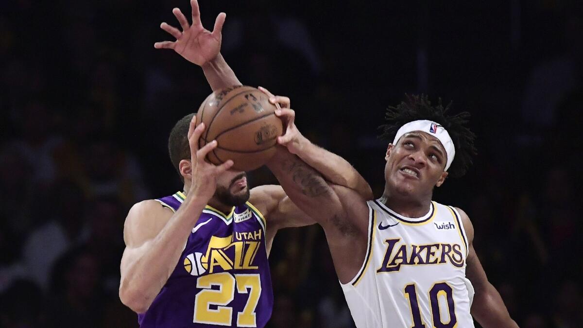 Lakers forward Jemerrio Jones battles Jazz center Rudy Gobert for a rebound Sunday.