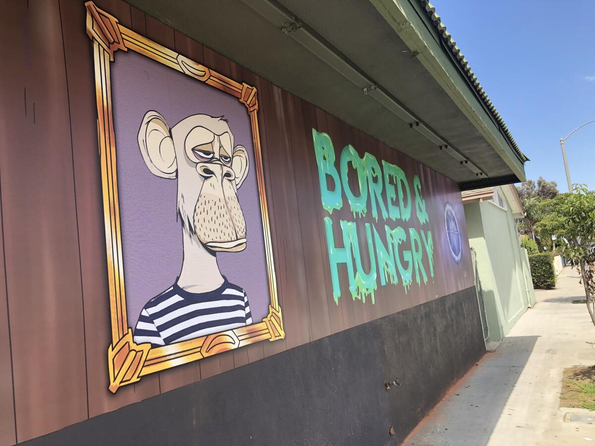 The exterior of Bored & Hungry shows a Bored Ape NFT and the name of the fast-food restaurant.