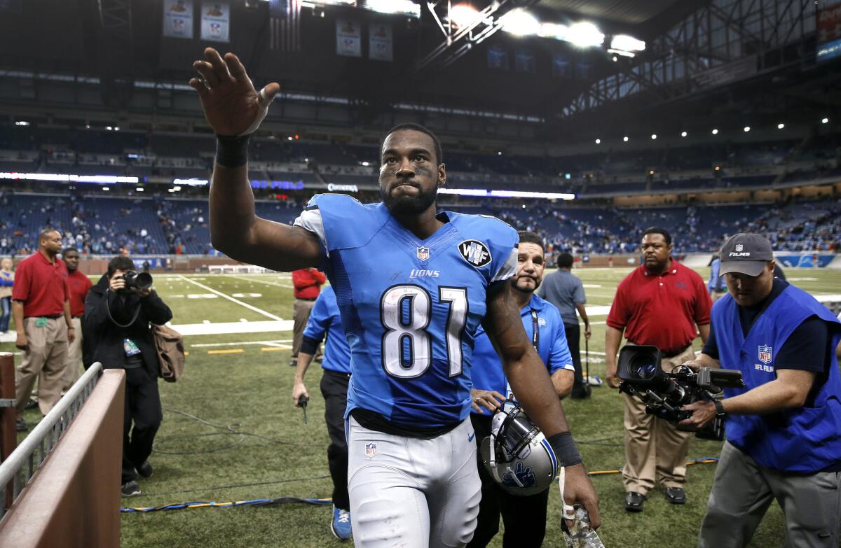 Detroit wide receiver Calvin Johnson waves to fans after a game against Miami on Nov. 9, 2014.