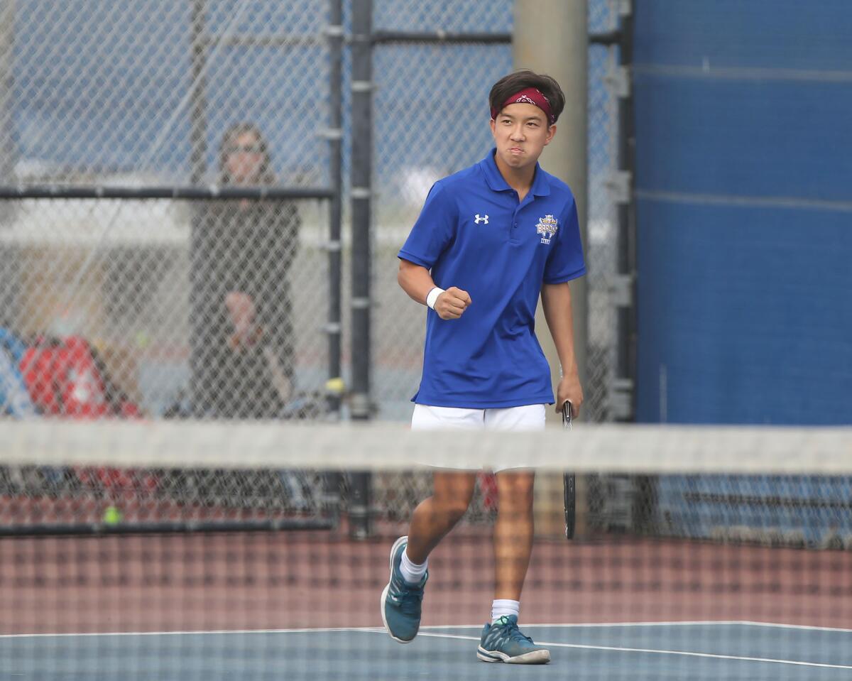 Fountain Valley singles player Alan Ton celebrates after winning a set against Beckman in a nonleague match at home Thursday.