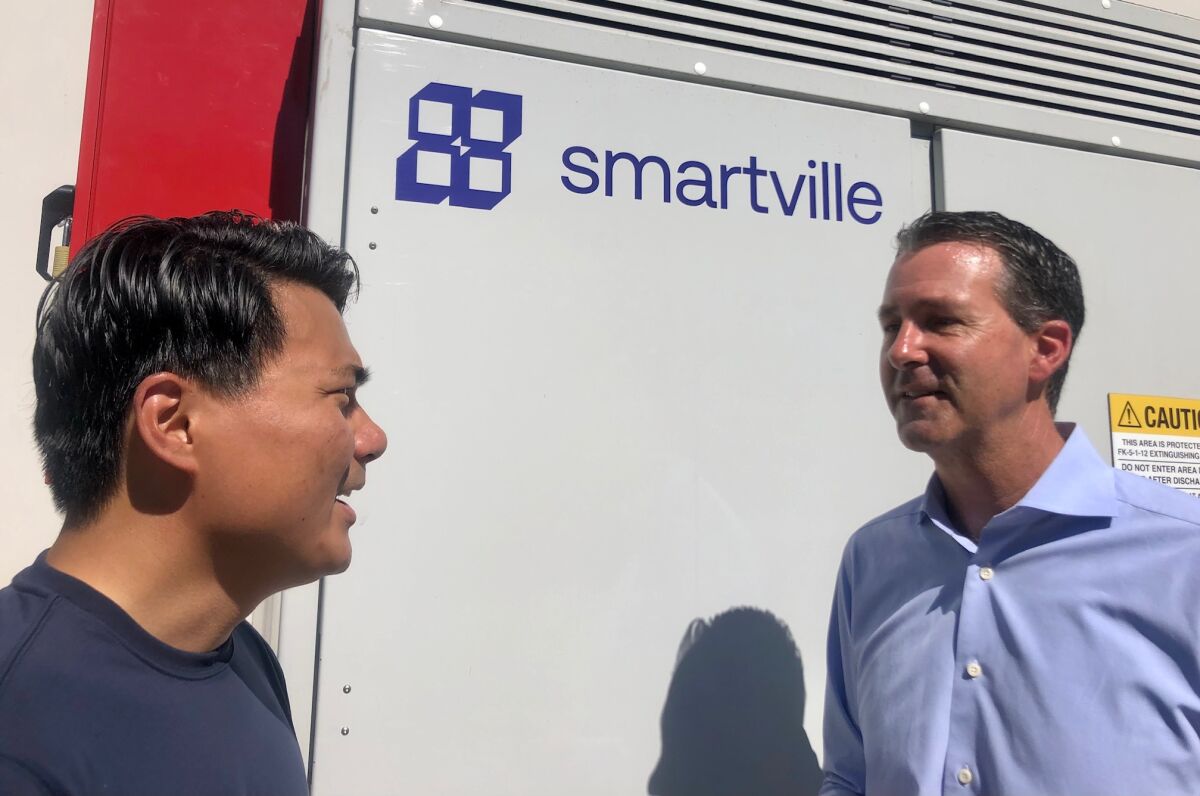Smartville Inc. CEO Antoni Tong talks to company president Mike Ferry.