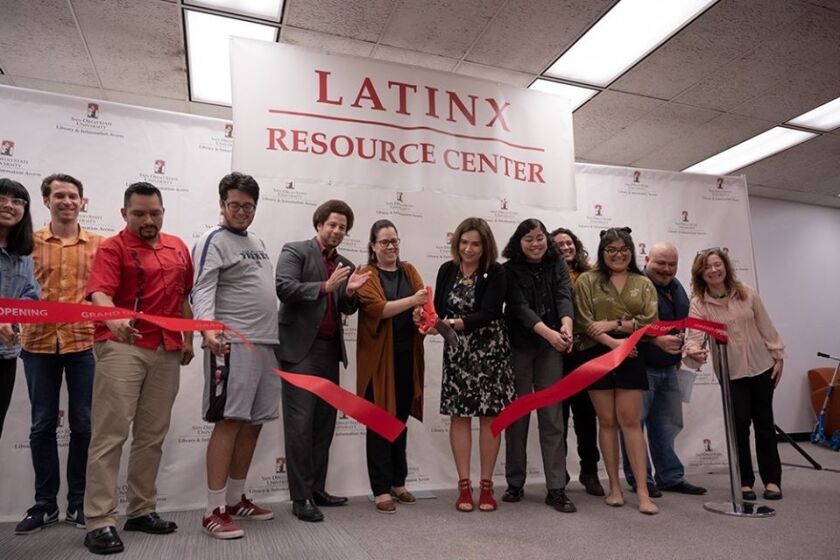 The Latinx Resource Center was opened at San Diego State University in February of 2020. In this photo, President Adela de la Torre is seen cutting the ribbon for the opening of the center.