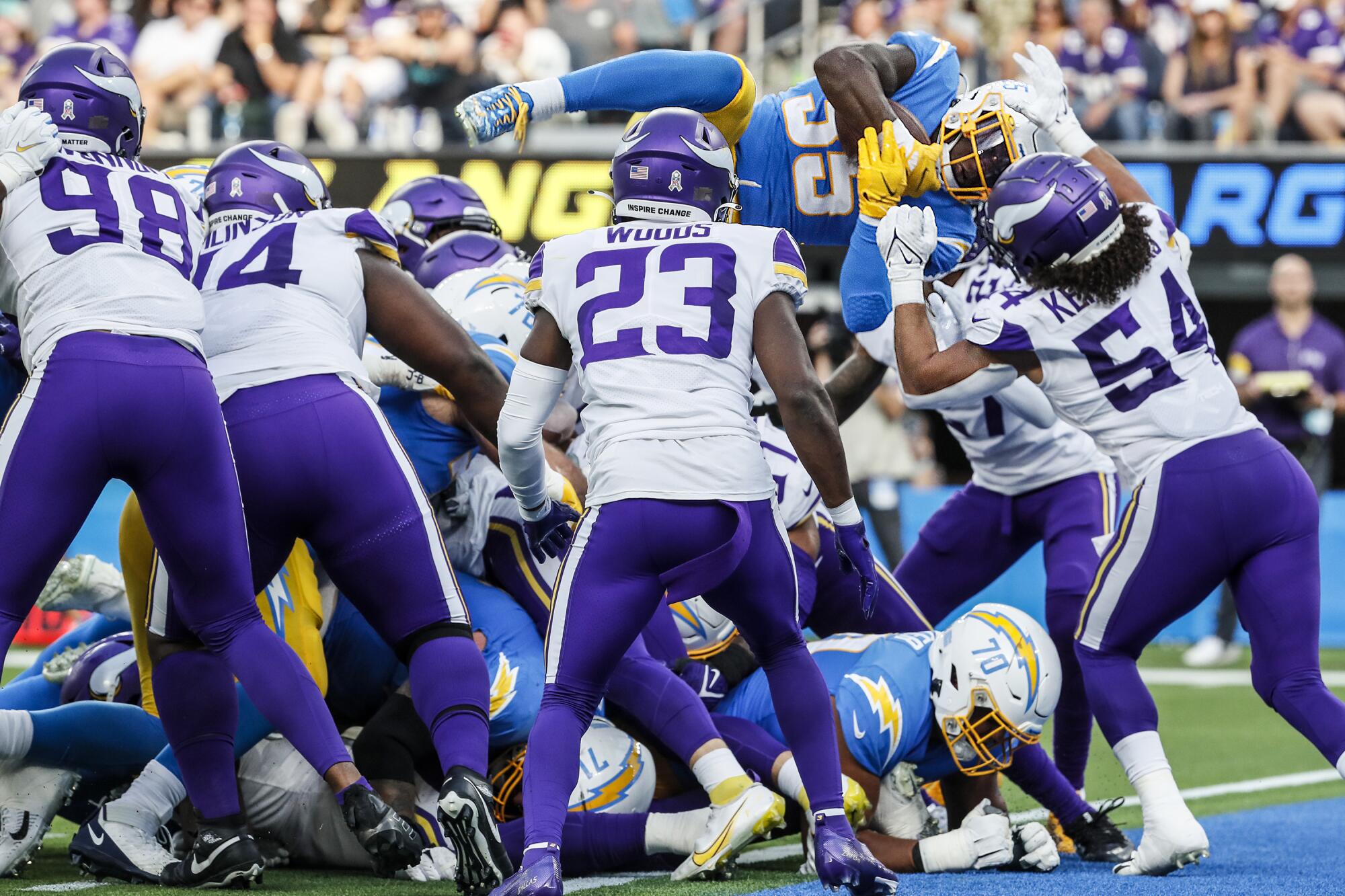 Chargers running back Larry Rountree III propels himself over the Minnesota Vikings defensive line.