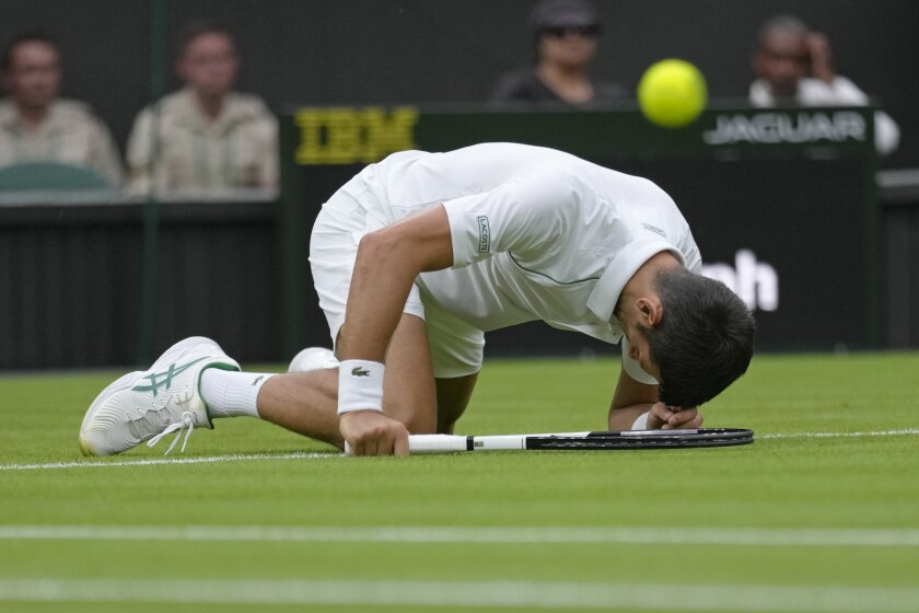 Serbia's Novak Djokovic slips over as he plays Korea's Kwon Soonwoo in a men's first round singles match on day one of the Wimbledon tennis championships in London, Monday, June 27, 2022. (AP Photo/Kirsty Wigglesworth)