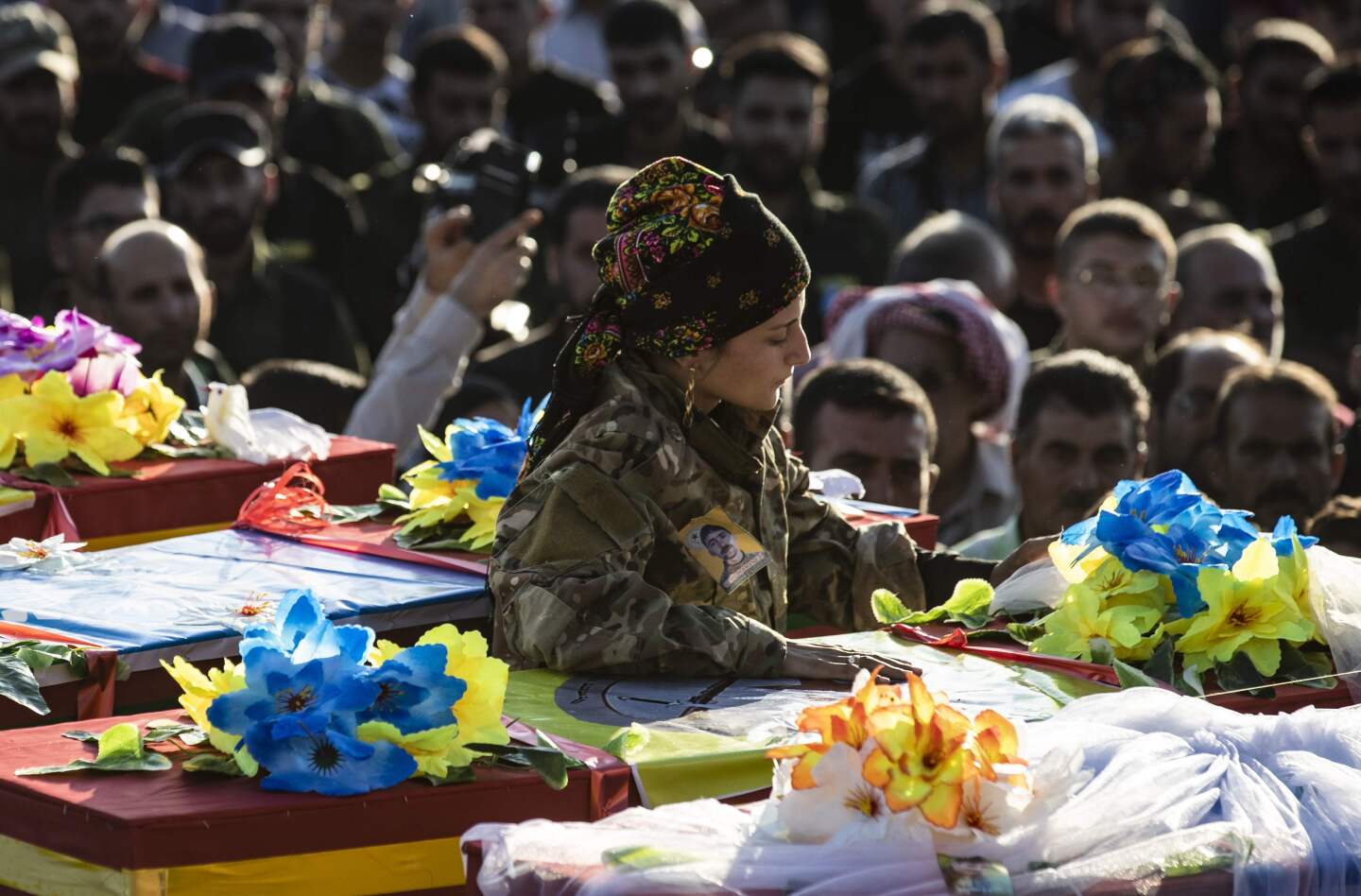 TOPSHOT - Mourners attend the funeral of five Syrian Democratic Forces' fighters killed in battles against Turkey-led forces in the flashpoint town of Ras al-Ain along the border, on October 14, 2019 in the Syrian Kurdish town of Qamishli. - The Syrian regime sent troops towards the Turkish border today to contain Ankara's deadly offensive against the Kurds, stepping in for US forces due to begin a controversial withdrawal. (Photo by Delil SOULEIMAN / AFP) (Photo by DELIL SOULEIMAN/AFP via Getty Images) ** OUTS - ELSENT, FPG, CM - OUTS * NM, PH, VA if sourced by CT, LA or MoD **