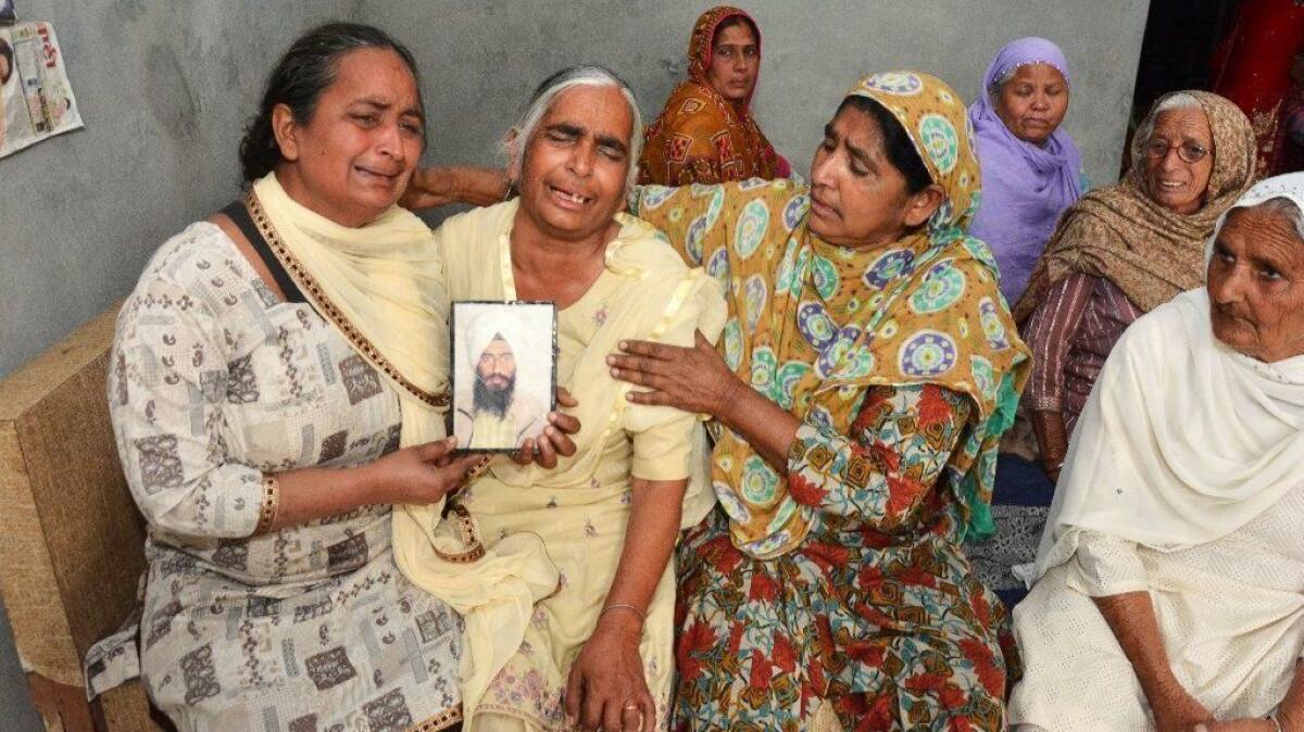 Relatives mourn Gurcharan Singh, one of the 38 Indian workers whose bodies Iraqi authorities found buried northwest of Mosul.