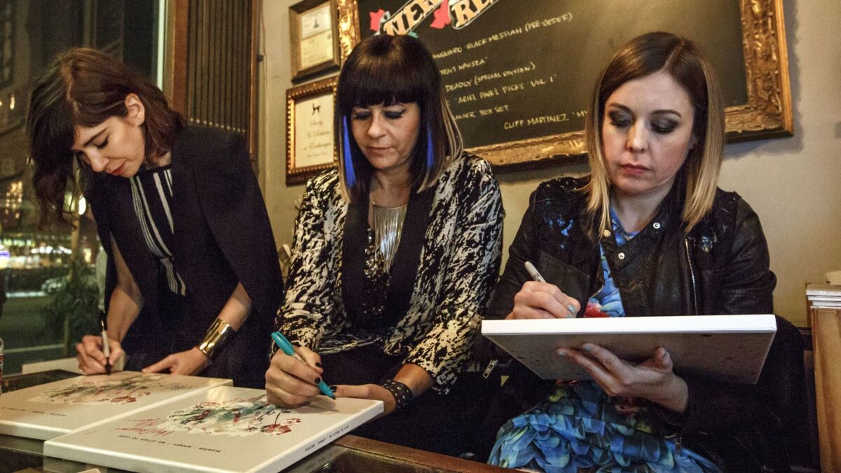 Drummer Janet Weiss, center, with Sleater-Kinney bandmates Carrie Brownstein, left, and Corin Tucker during a signing in 2015.