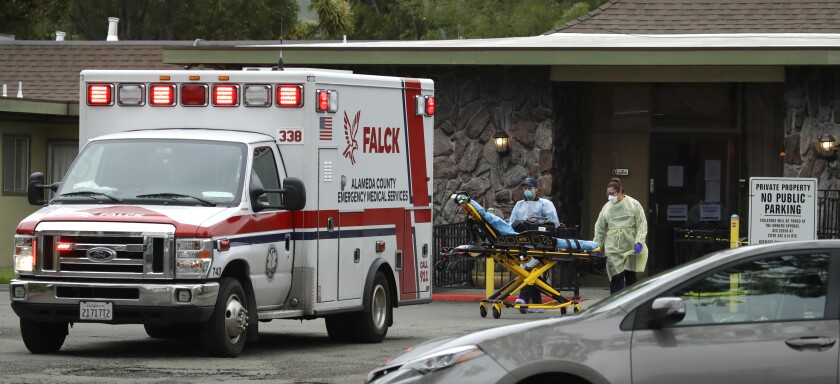 Emergency healthcare workers move a stretcher at the Gateway Care and Rehabilitation Center on April 9 in Hayward, Calif.