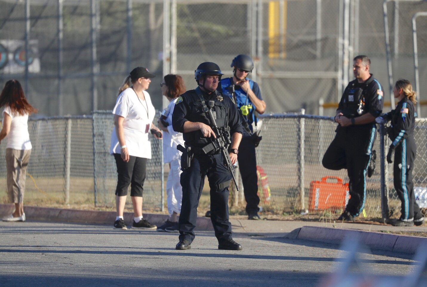 A police officer stands guard outside Gilroy High School soon after the July 28 mass shooting that occurred at a nearby festival site.(Nhat V. Meyer / Associated Press)