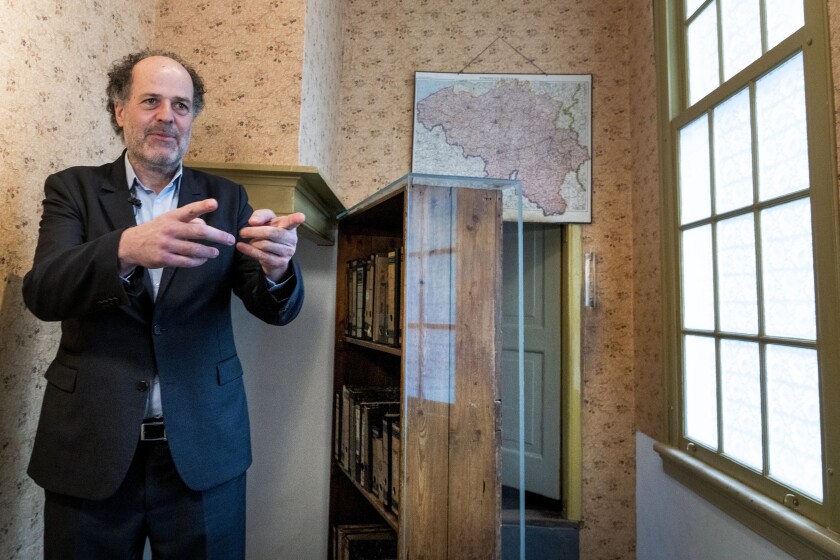Ronald Leopold, executive director Anne Frank House, gestures as he talks next to the passage to the secret annex during an interview in Amsterdam, Netherlands, Monday, Jan. 17, 2022. A cold case team that combed through evidence for five years may have solved one of World War II's enduring mysteries: Who betrayed Jewish teenage diarist Anne Frank and her family? Their answer, outlined in a new book, is that it most likely was a Jewish lawyer called Arnold van den Bergh. (AP Photo/Peter Dejong)
