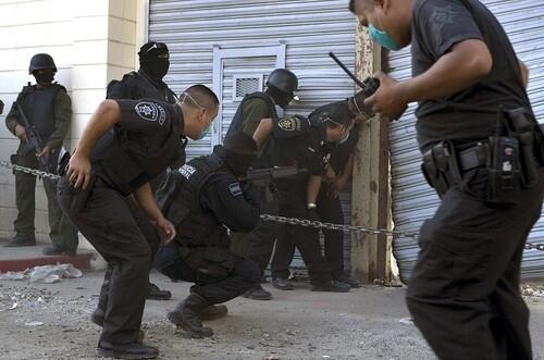 Federal police officers guard a door at La Mesa State Penitentiary.