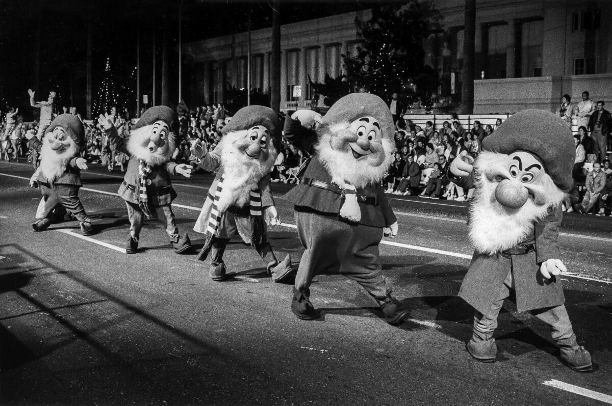 Nov. 27, 1988: A few of the seven Disney dwarves march in the Hollywood Christmas Parade.