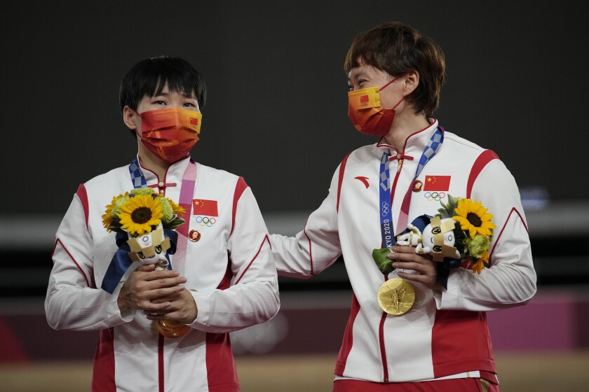 Bao Shanju and Zhong Tianshi of China wear pins with depictions of Mao Zedong at the Tokyo Olympics.