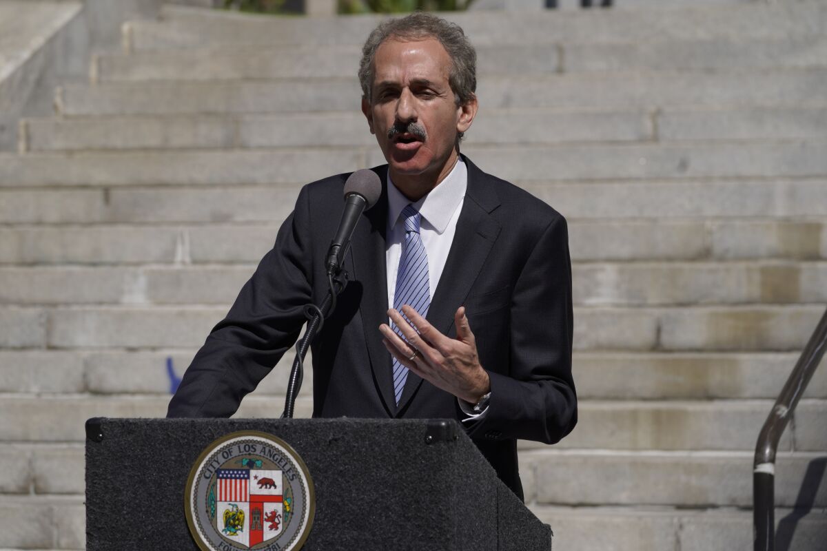Los Angeles City Attorney Mike Feuer announces a lawsuit seeking environmental justice from Monsanto and two related companies for pollution of the City's waterways with polychlorinated biphenyls (PCBs) at a news conference outside Los Angeles City Hall, March 7, 2022. The lawsuit seeks to force Monsanto to abate PCB pollution and reimburse the City for costs it has already incurred. (AP Photo/Damian Dovarganes)