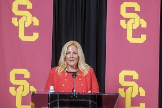 USC athletic director Jennifer Cohen stands at a podium and speaks to media after being introduced 