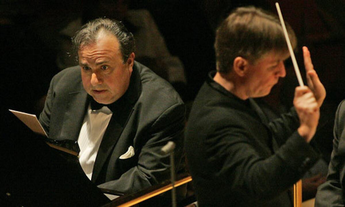 Yefim Bronfman, left, plays piano as Esa-Pekka Salonen conducts the LA Philharmonic performing a piano concerto by Salonen at the Walt Disney Concert Hall.
