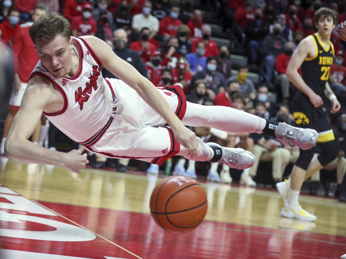 Rutgers forward Oskar Palmquist (1) makes a diving attempt to keep the ball in bounds during the first half of the team's NCAA college basketball game against Iowa on Wednesday, Jan. 19, 2022, in Piscataway, N.J. (Andrew Mills/NJ Advance Media via AP)