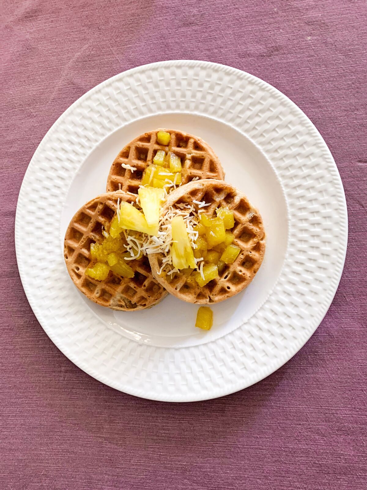 Piña Colada Waffles incorporate pineapple, toasted coconut and hazelnuts, with a topping of pineapple sauce.