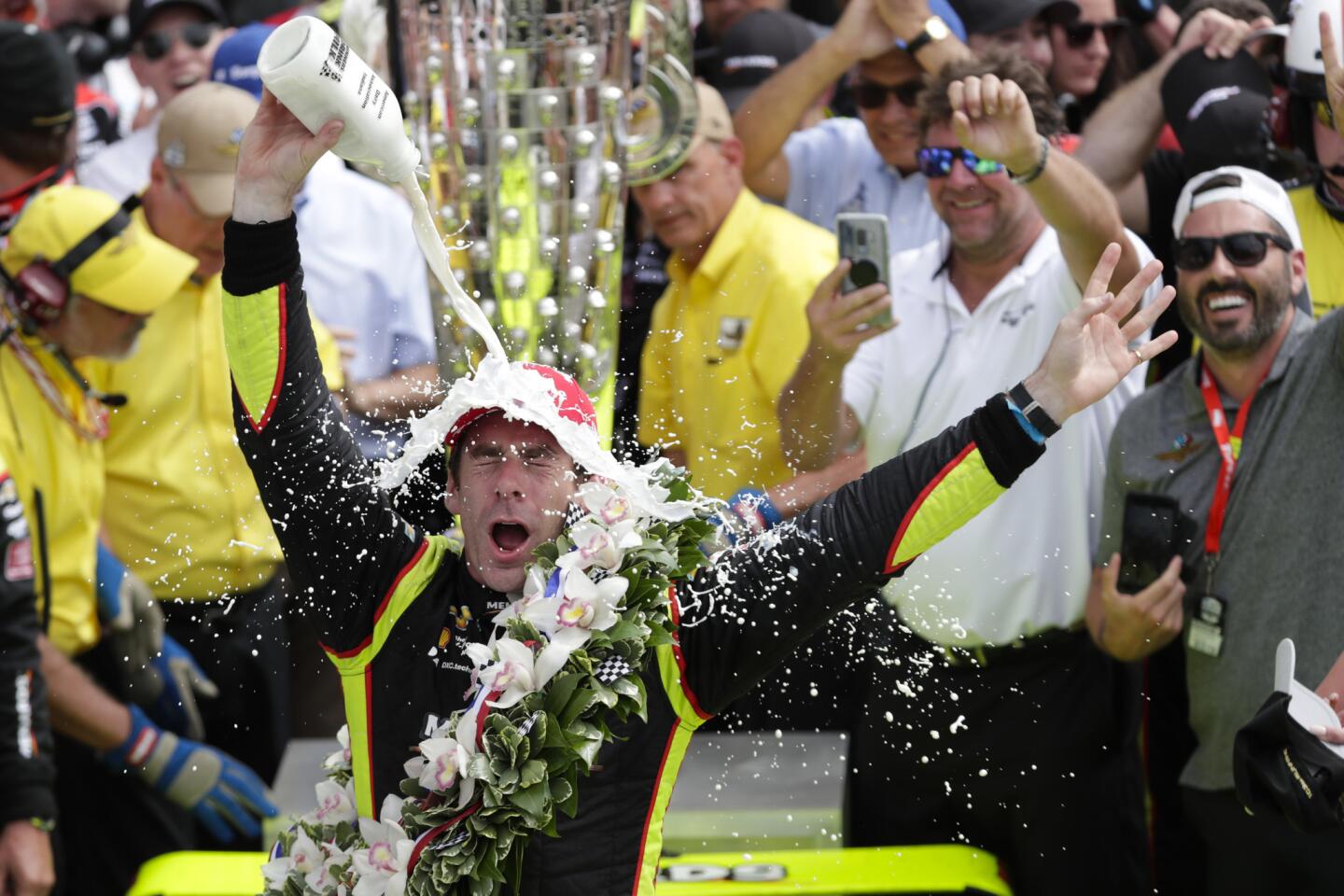Indy 500 winner Simon Pagenaud celebrates with the traditional glass of milk in Victory Lane.