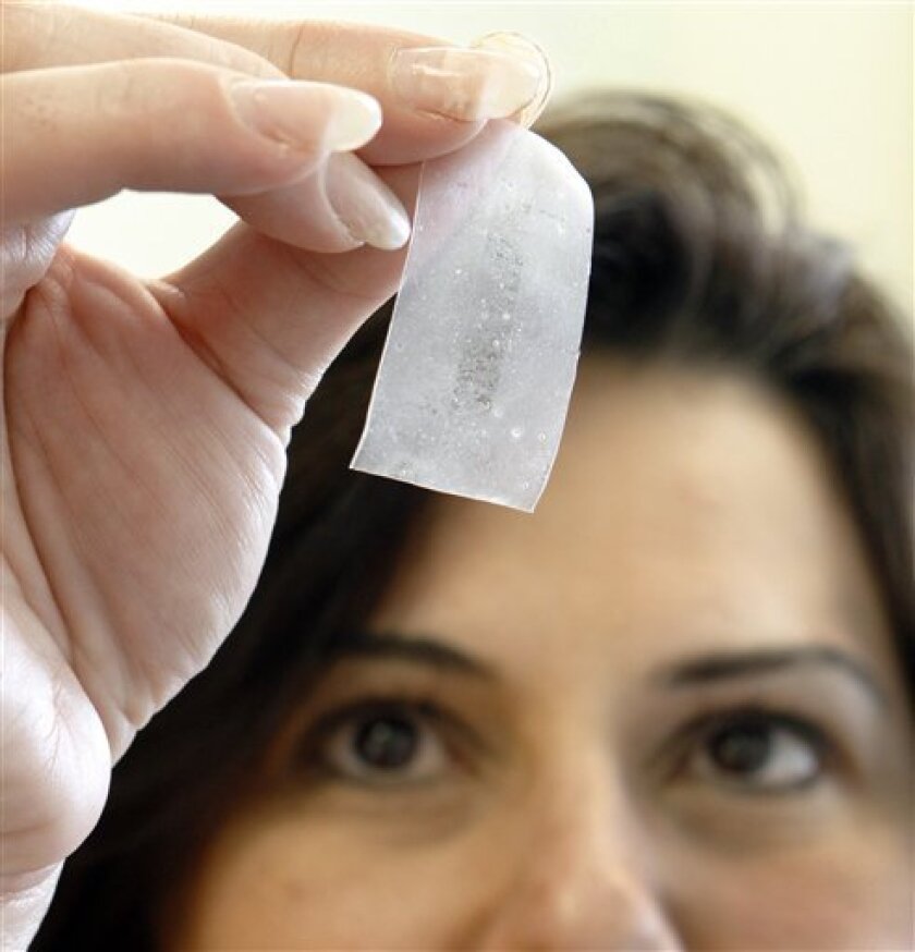 In this photo taken Friday, May 14, 2010, at the MaGee Womens Research Institute in Pittsburgh, lead researcher Lisa Rohan shows a vaginal film formulated with drugs to target against HIV infection. (AP Photo/Keith Srakocic)