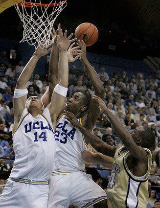 UCLA's Lorenzo Mata goes up for a rebound with teammate Luc Richard Mbah A Moute.