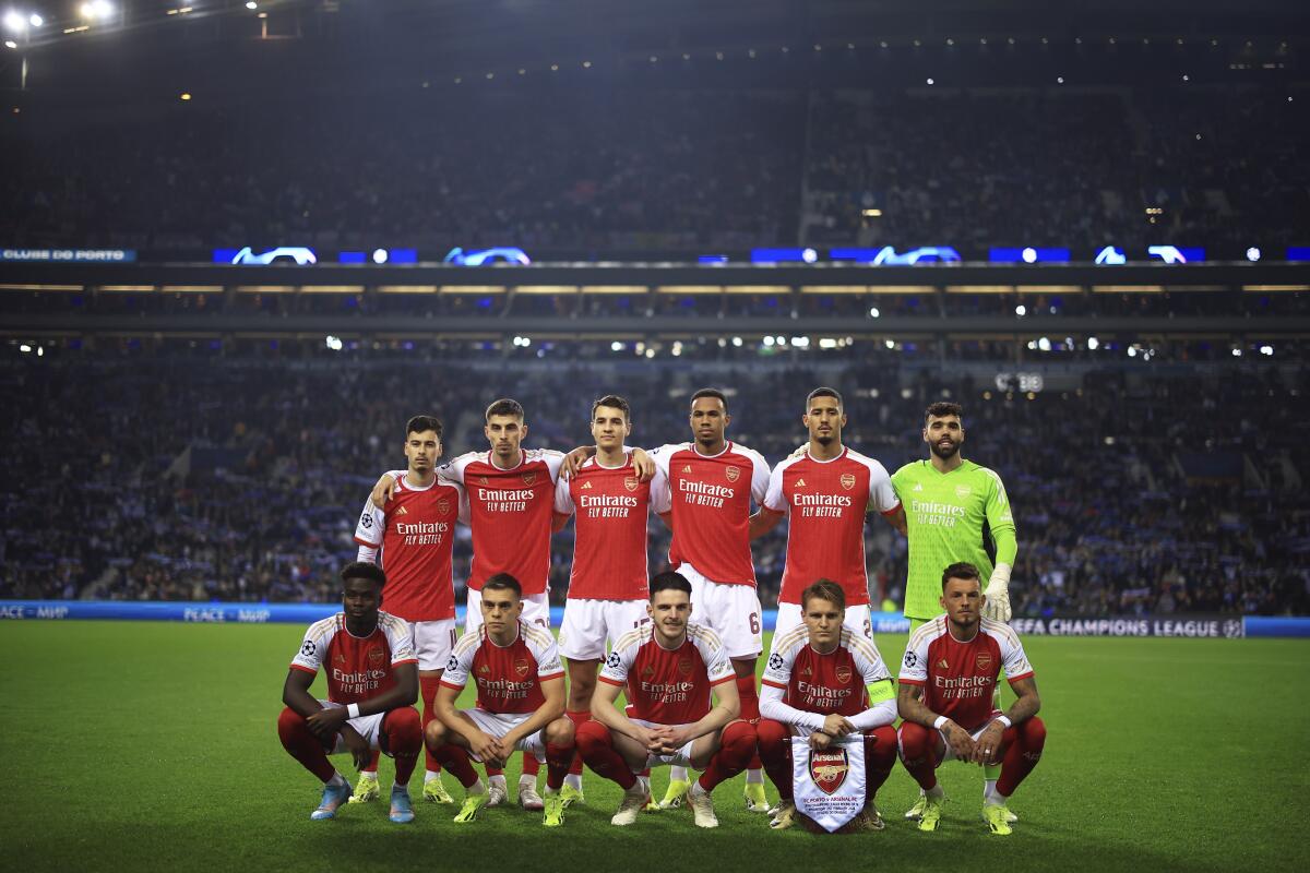 Arsenal players pose before a Champions League 