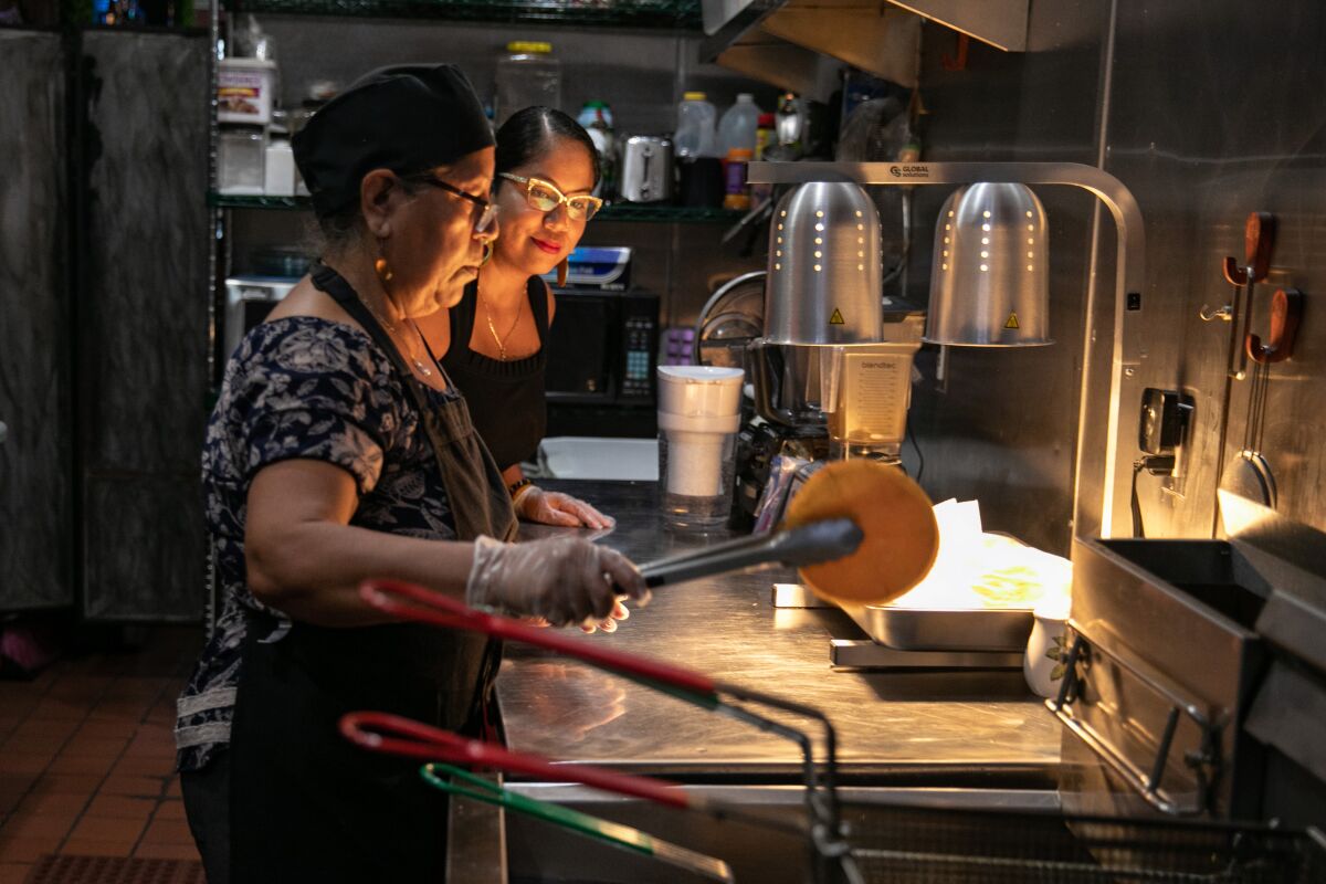 Two women cook in a restaurant 