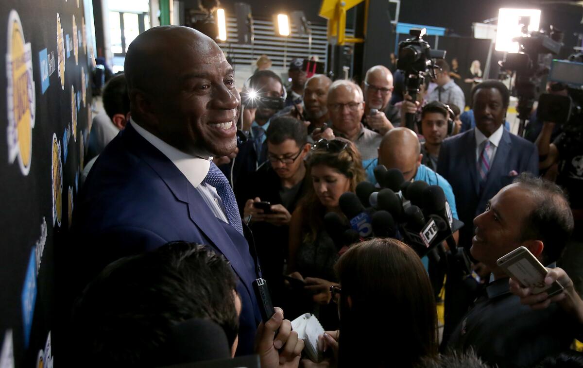 Magic Johnson, the Lakers' president of basketball operations, talks with reporters during media day at the team's new training facility in El Segundo.