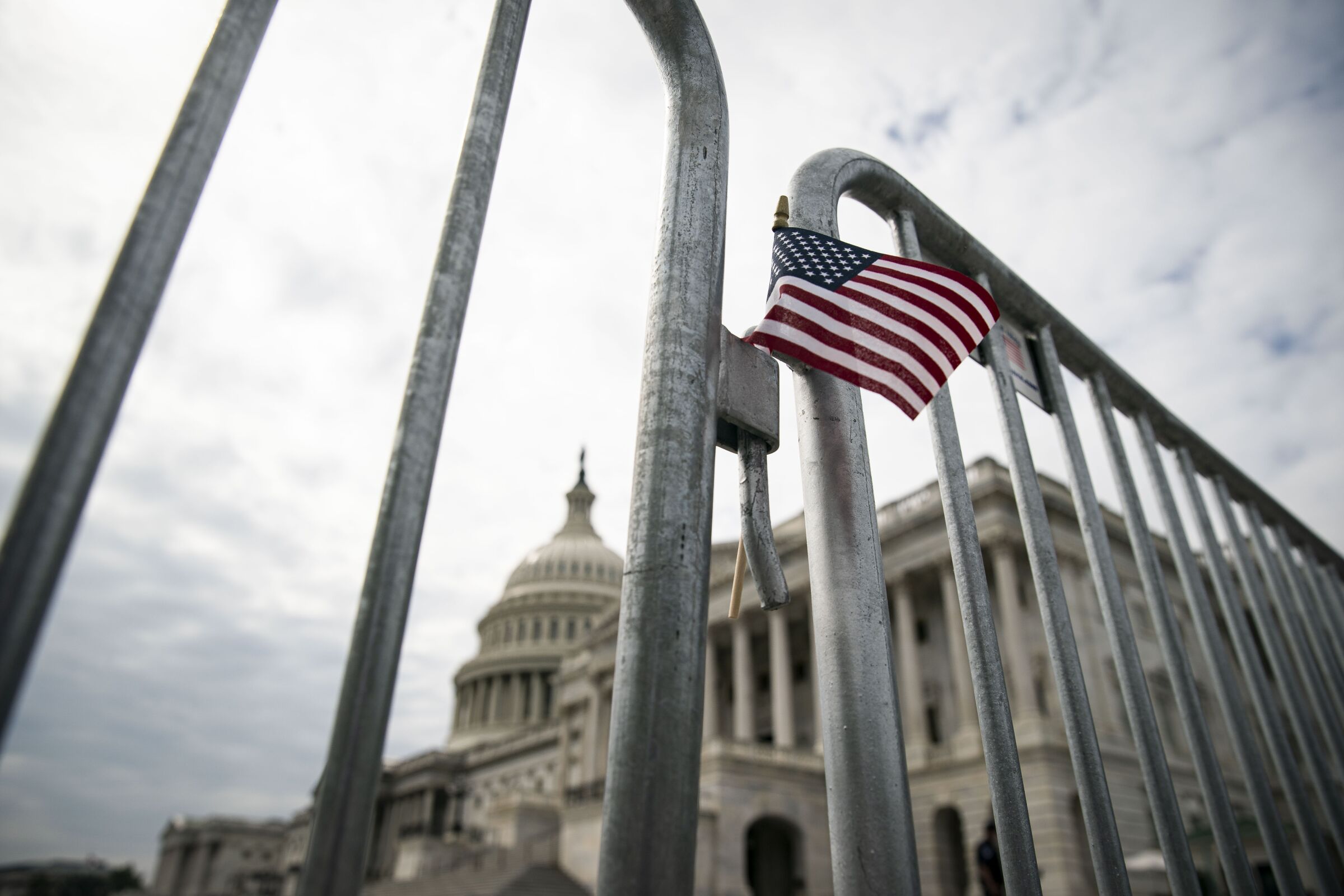 A small American flag on a fence outside the Capitol in Washington.