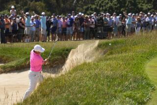 Tom Kim hits from the bunker on the 15th hole during the third round of the U.S. Open golf tournament.