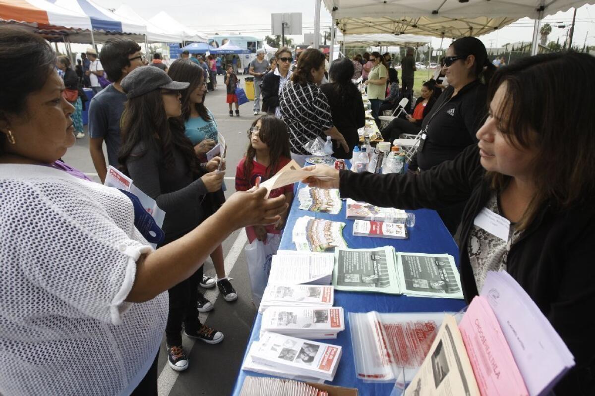 Socorro Guzman, left, gets information about Obamacare from Martha Chehadi of the Whittier Health Center at an enrollment event in East Los Angeles.