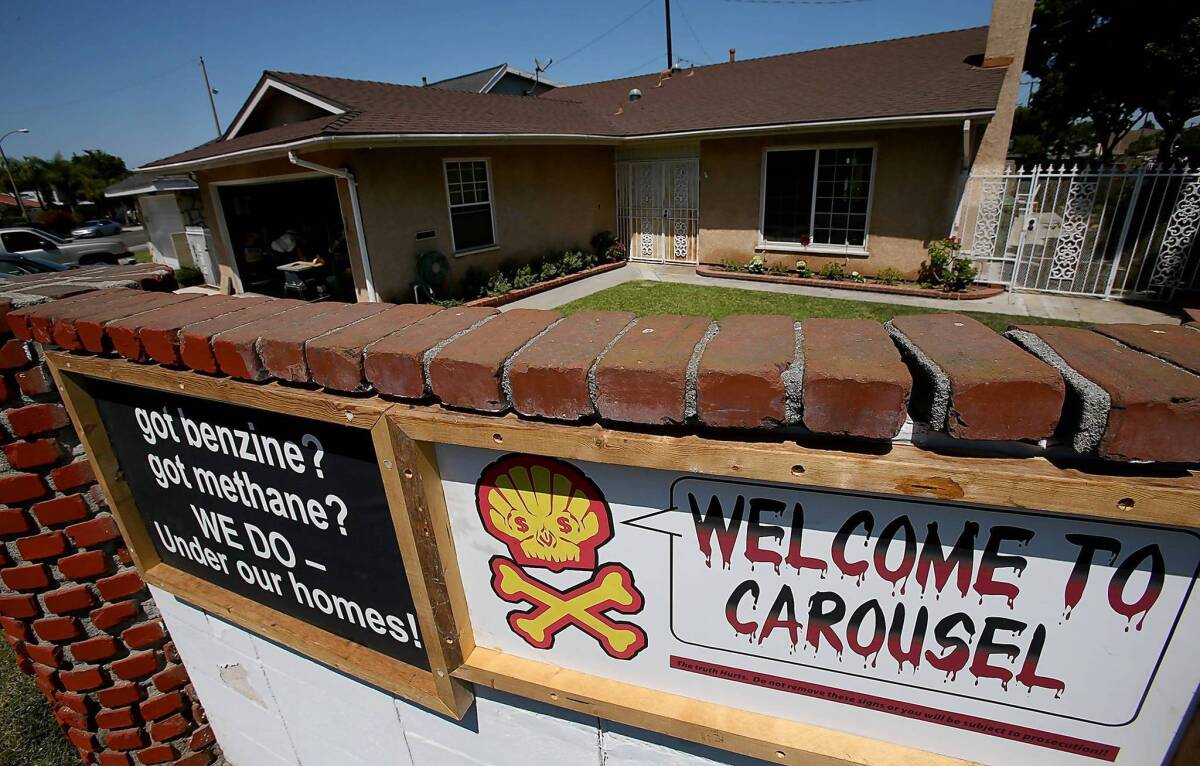 Signs warning of severe ground contamination greet visitors at the entrance to the Carousel residential subdivision in Carson. City officials are seeking to declare a local emergency in an effort to pressure the state and an oil company to speed cleanup.