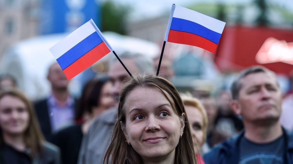 A woman wears Russian flags on her head during the opening ceremony of the FIFA Fan Fest in Saransk on June 12.