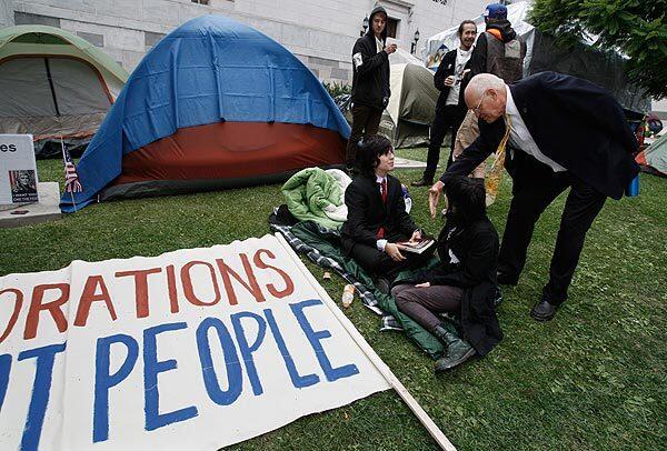 Los Angeles City Councilman Bill Rosendahl meets with some of the protesters at the Occupy Los Angeles campsite outside Los Angeles City Hall on Tuesday.