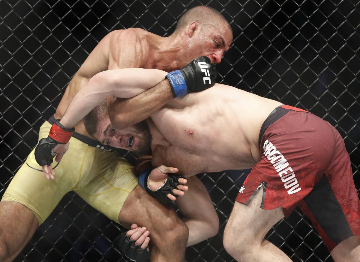 Khabib Nurmagomedov, right, tries to take down Edson Barboza in a lightweight bout at UFC 219.