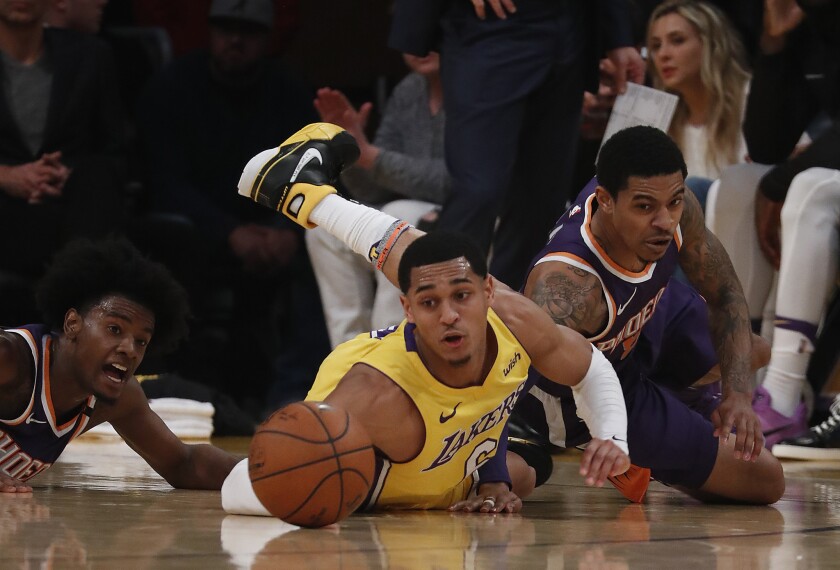 Lakers guard Jordan Clarkson dives for a loose ball during the first quarter of a game Tuesday at Staples Center.