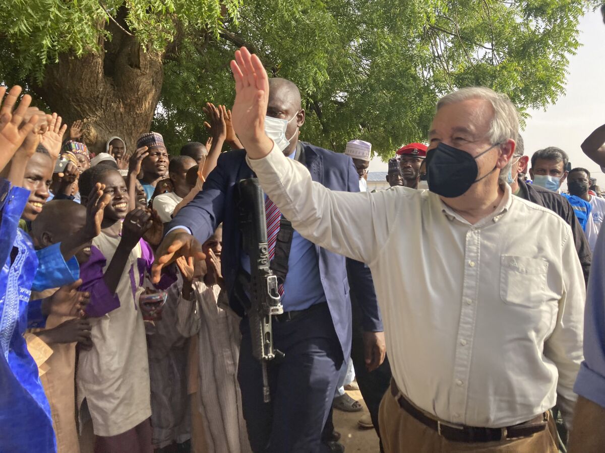 United Nations Secretary-General Antonio Guterres, waves to the crowds upon arrival in Maiduguri, Nigeria, Tuesday, May 3, 2022. Guterres on Tuesday said the reintegration of extremist rebels who have defected from the jihadi Boko Haram group that has waged a decade-long insurgency against the West African nation is "the best thing we can do for peace." (AP Photo/Chinedu Asadu)