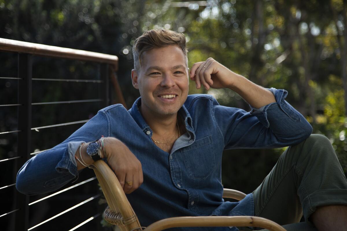 Zach Baylin sits outside for a portrait.