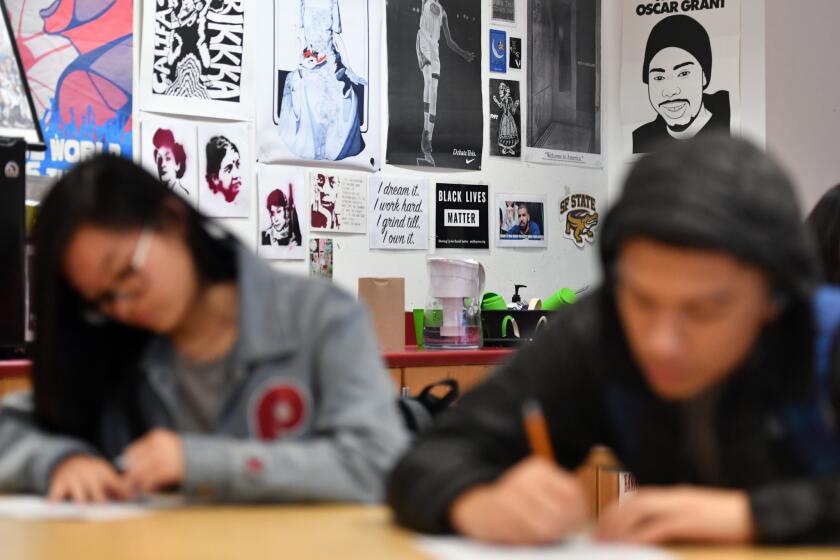 SAN FRANCISCO, CA - JANUARY 22, 2018 - Anti-racism signs are seen around a classroom as students work on assignments during an ethnic studies class at John O'Connell High School in San Francisco, California on January 22, 2018. (Josh Edelson / For the Times)