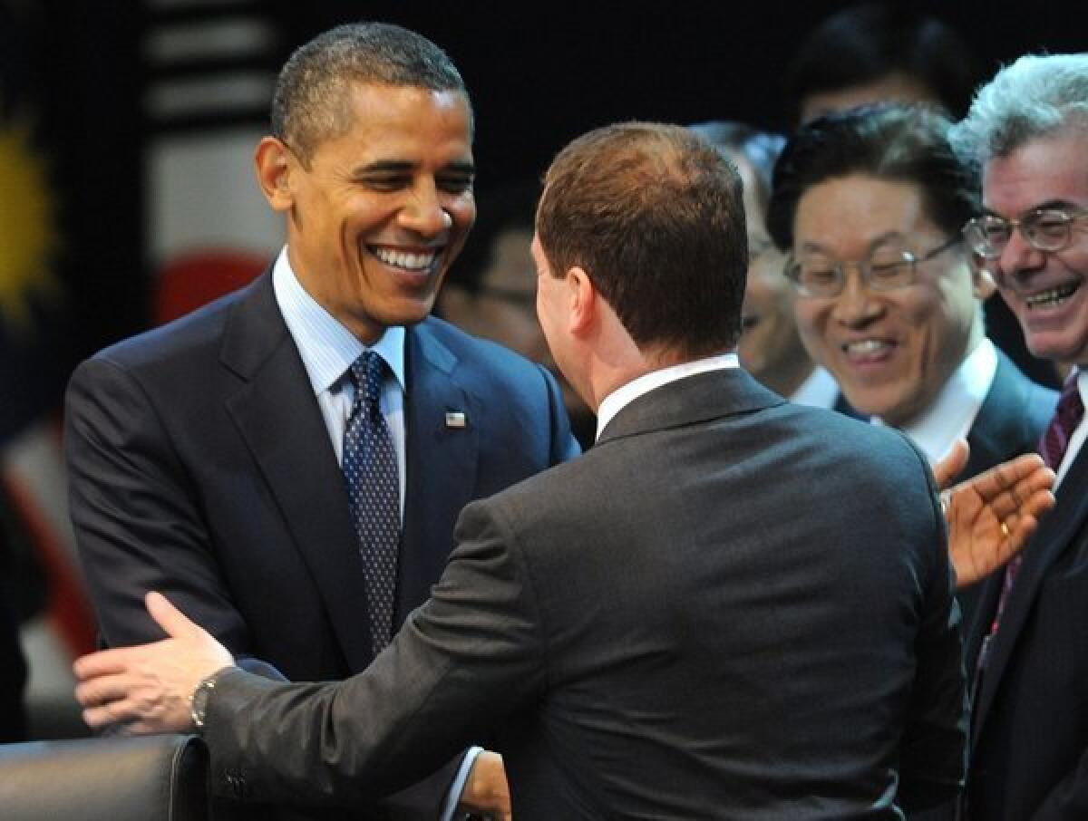 President Obama shakes hands with Russian President Dmitry Medvedev at the first plenary session of the 2012 Nuclear Security Summit in Seoul.