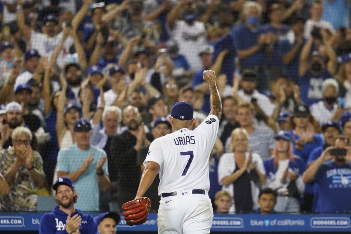 Dodgers pitcher Julio Urias raises his fist as he leaves the mound to a standing ovation.
