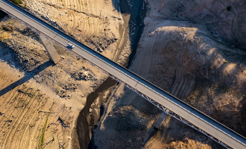 A truck crosses the Enterprise Bridge at Lake Oroville, which is 33% full