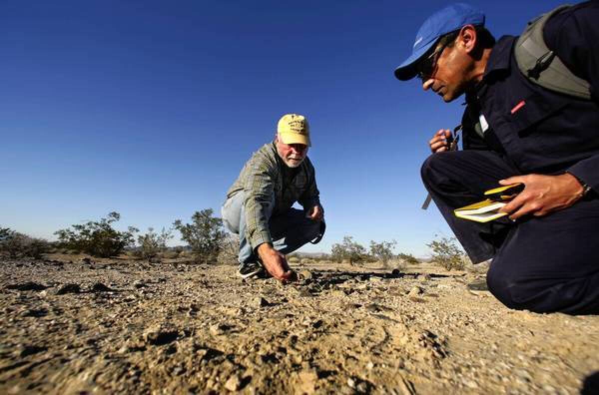 Molecular biologist and entrepreneur J. Craig Venter, left, and microbiologist Gerardo Toledo collect microbe samples at Mojave National Preserve. Venter is field-testing technology he says will revolutionize the search for extraterrestrial life.