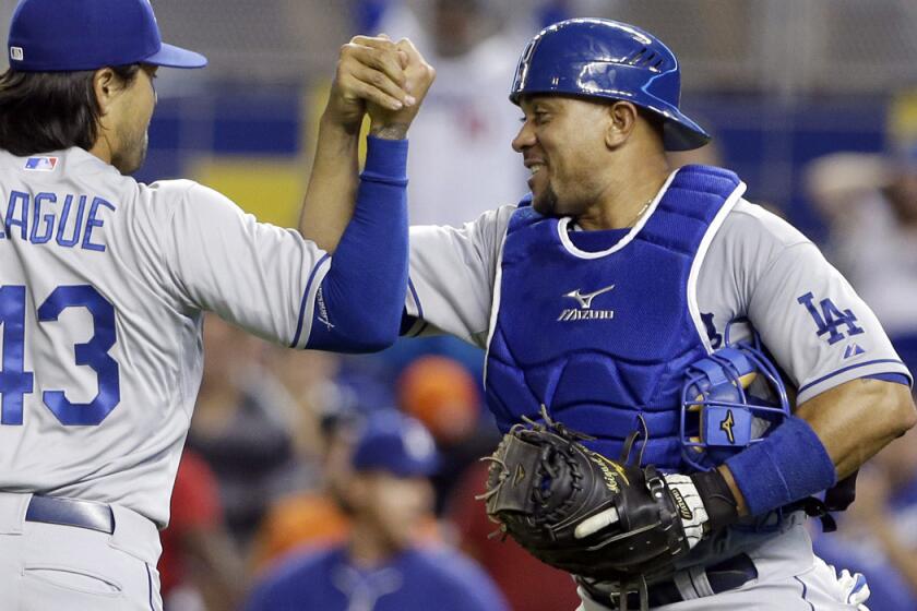 Dodgers reliever Brandon League is congratulated by catcher Miguel Olivo in happier times, after a 9-7 victory over the Miami Marlins on May 3.