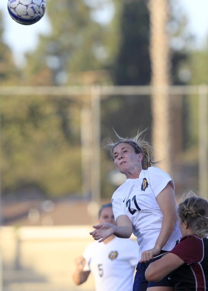 Vanguard's Angela Hook (21) heads the ball during the second half against Westmont at Biola University in La Mirada on Tuesday.