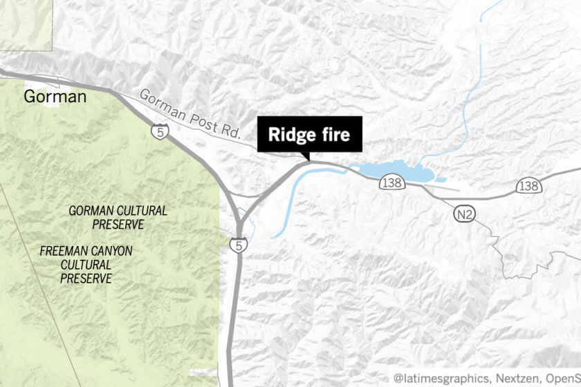 Firefighters were working to contain the 100-acre Ridge fire on Monday afternoon.