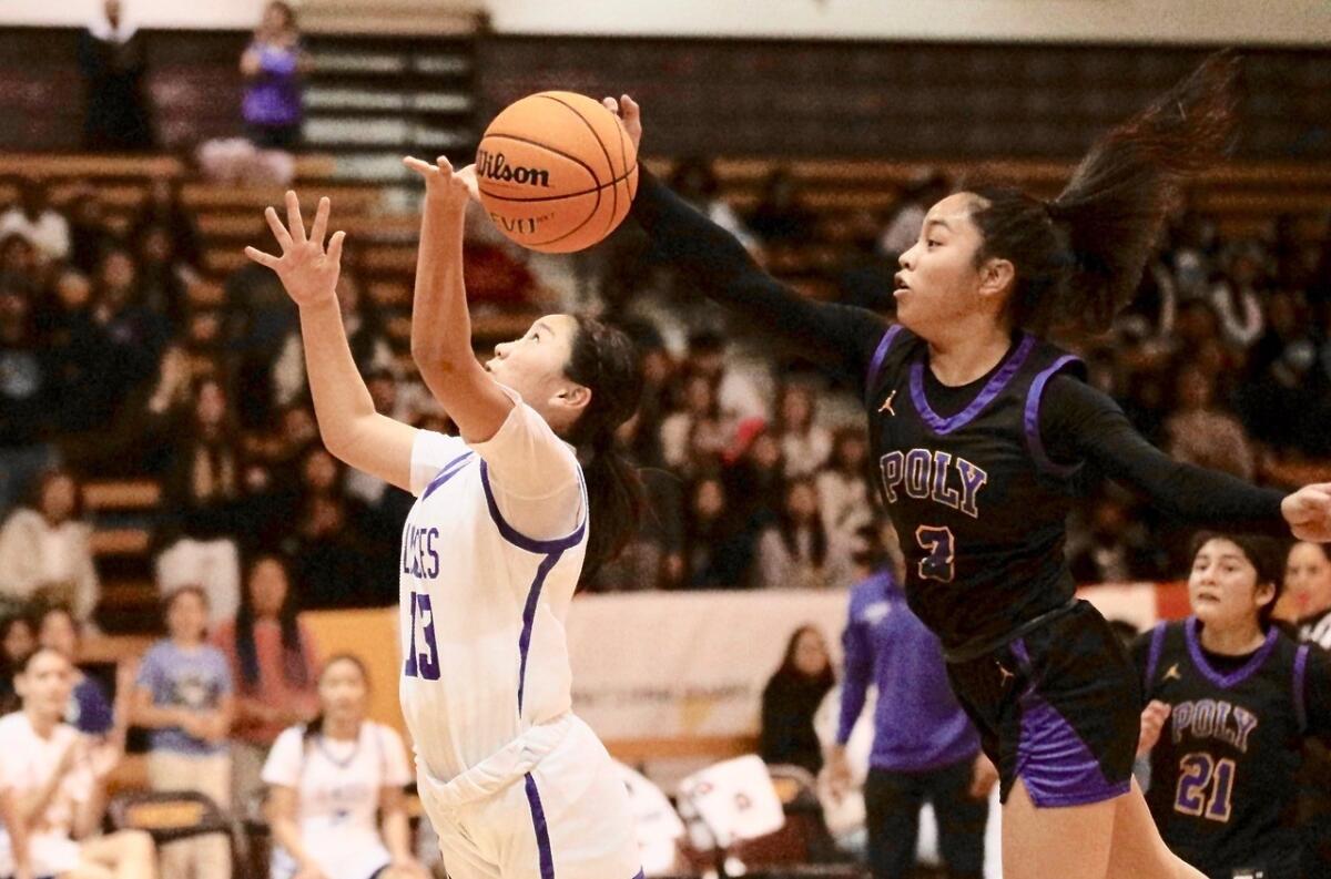 Poly guard Hannah Lising blocks a shot by LACES guard Maya Sano in the City Section Division I girls' basketball final.