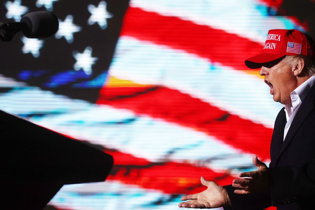 Former President Donald Trump in front of a flag image at a Jan. 15 rally in Arizona