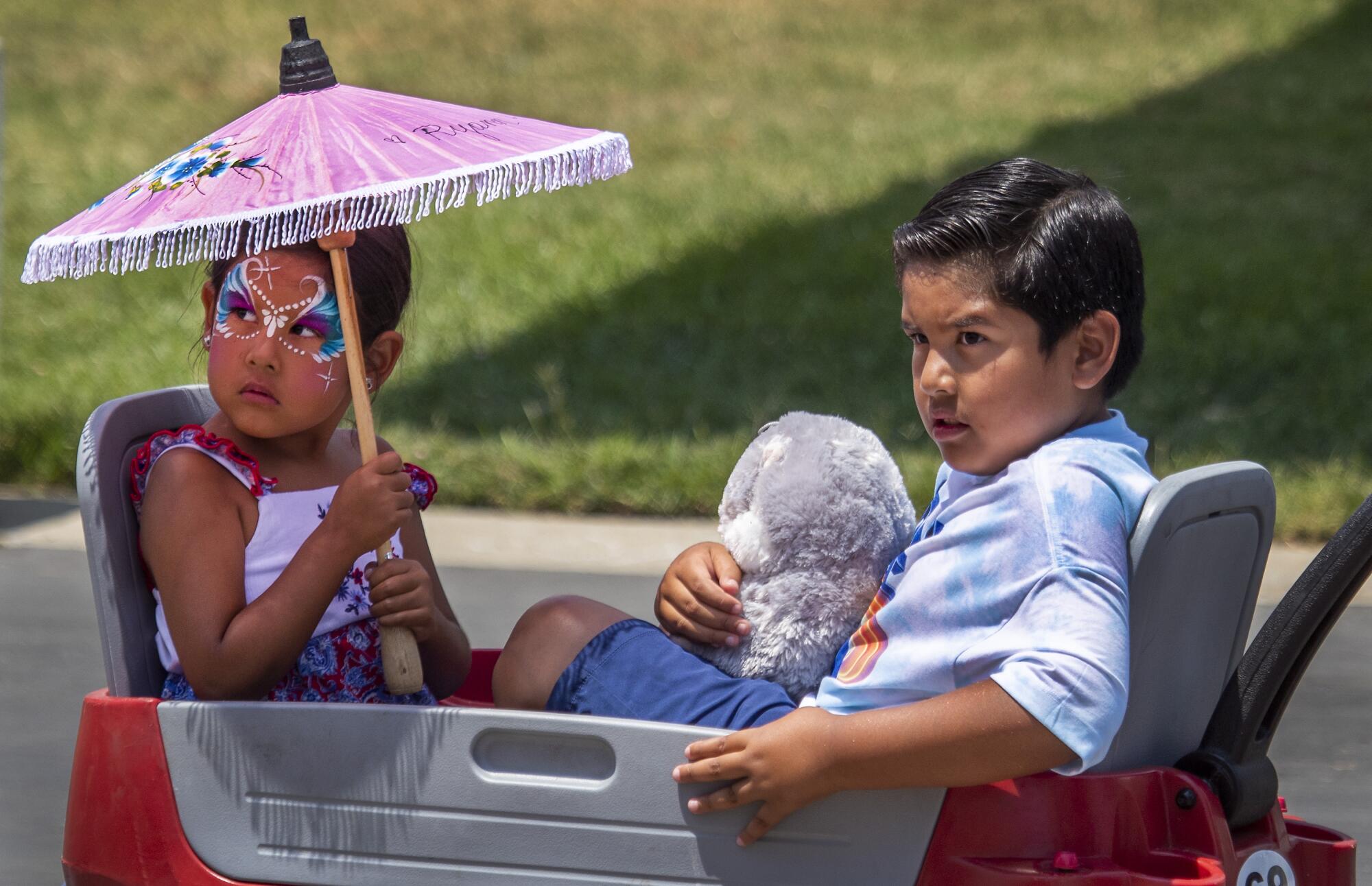 Ryann Garcia, 5, and Andrian Garcia, 8, of Los Alamitos, are pulled in a wagon.