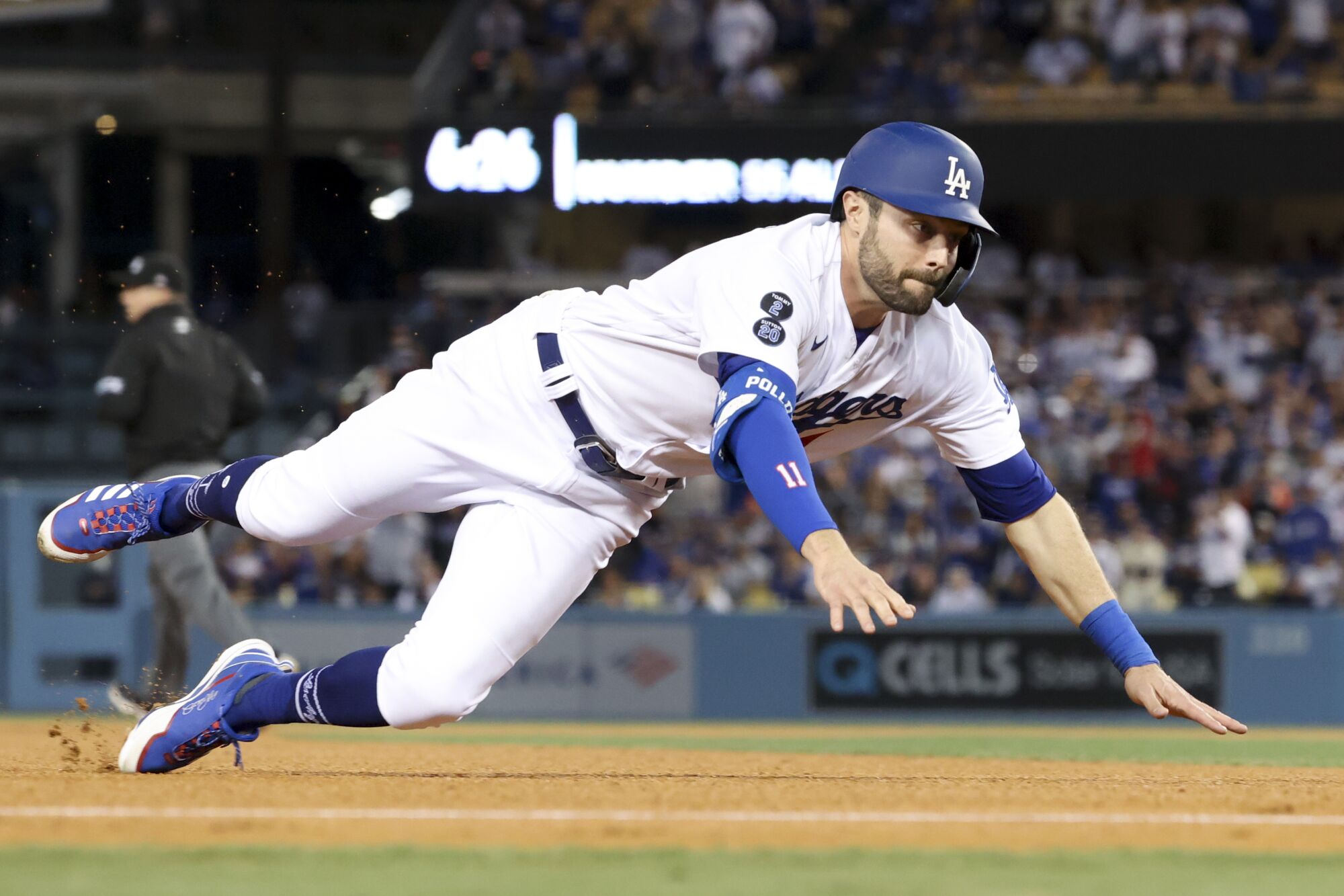  Dodgers' AJ Pollock dives into third base off a single by Albert Pujols.